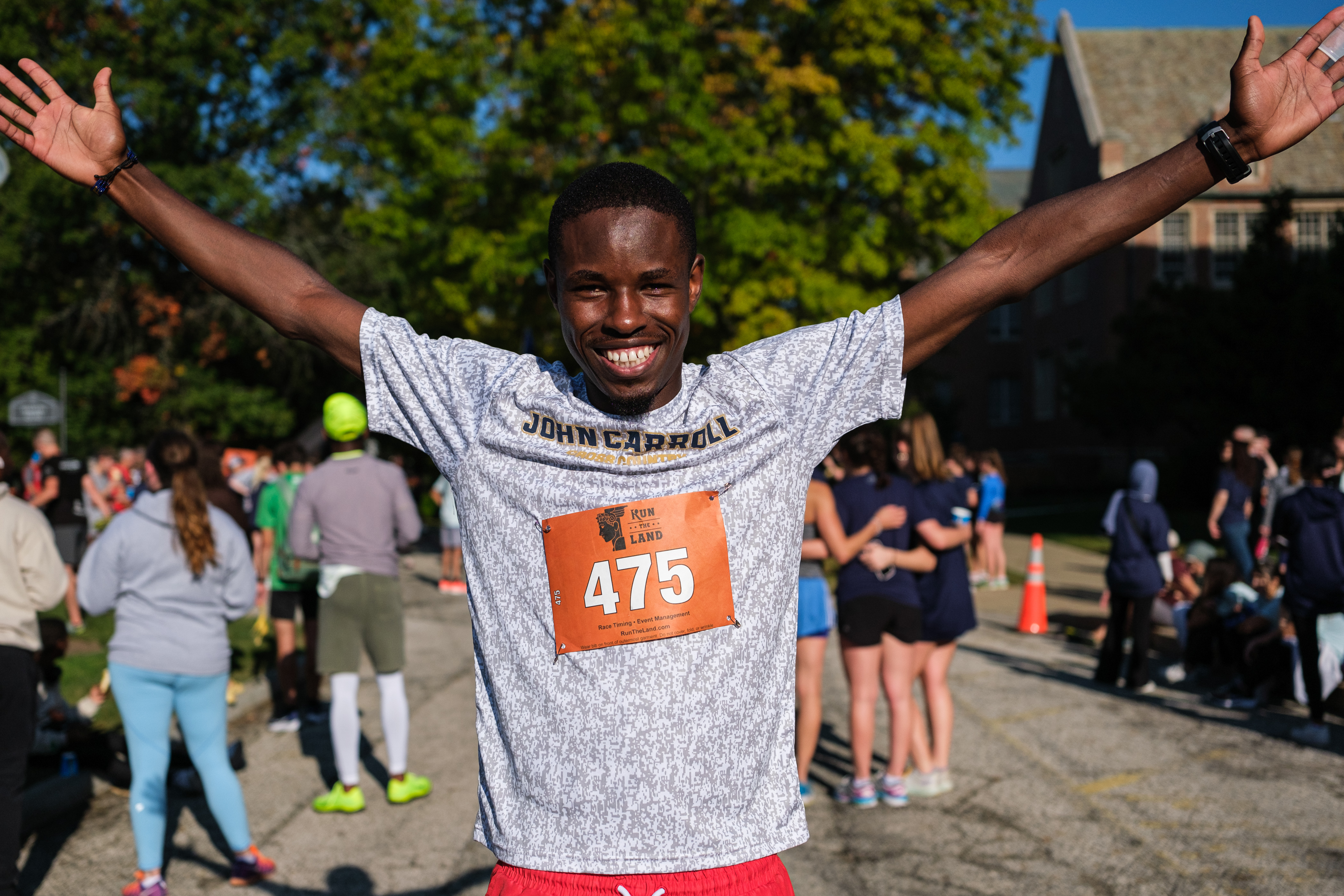 Young jcu student celebrating after running footsteps for fatima race