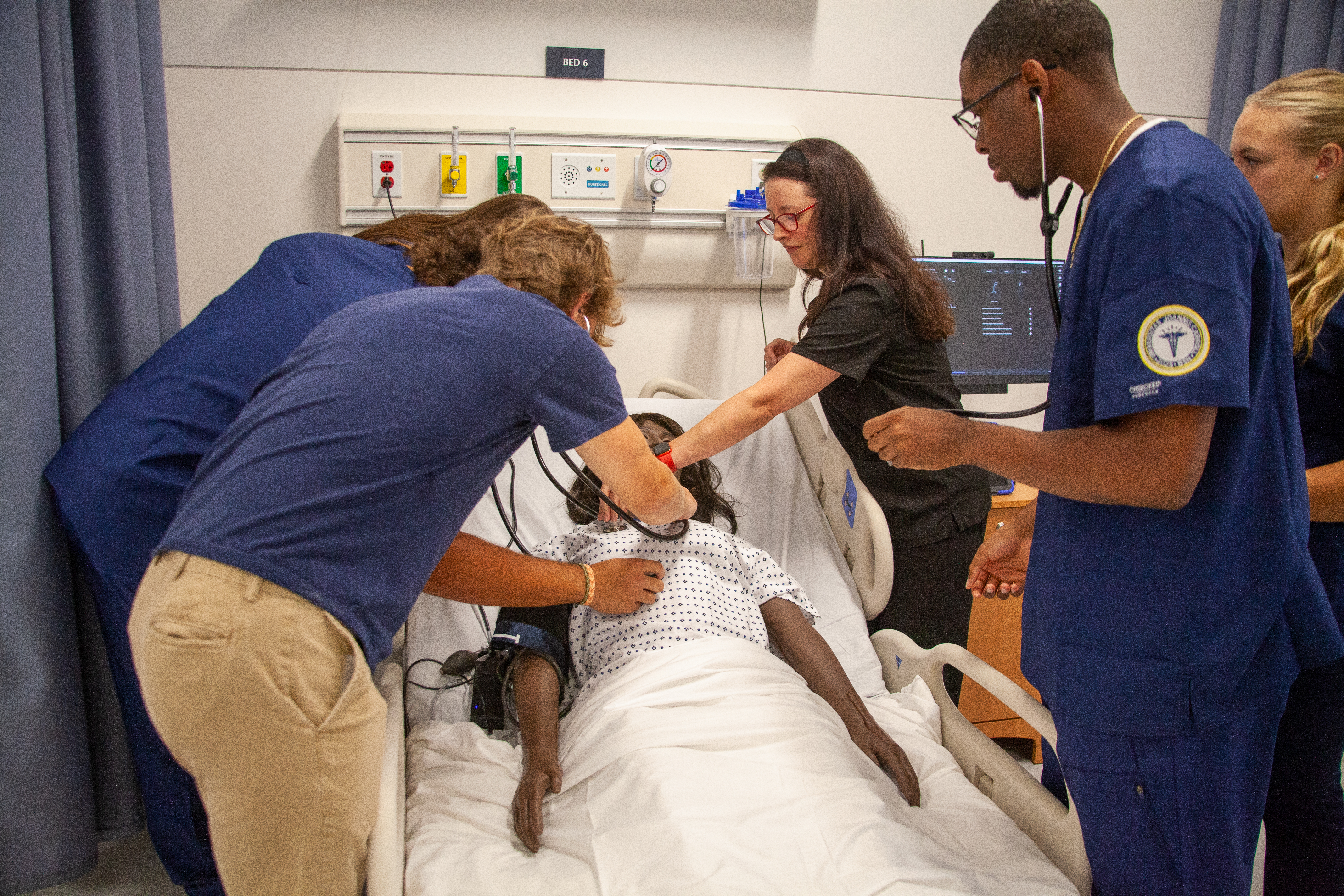 Nursing students learning with medical manniquin