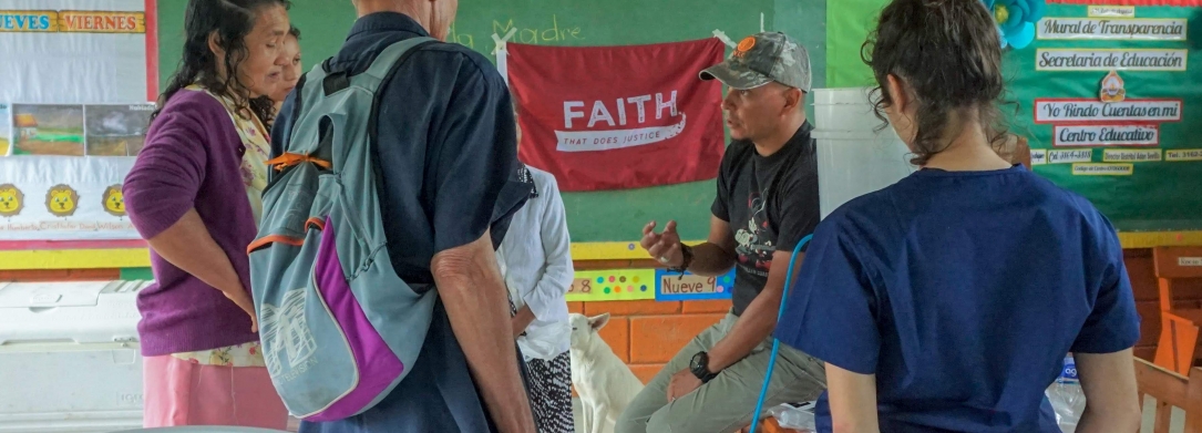 Students listen to one of the community members on an immersion trip.