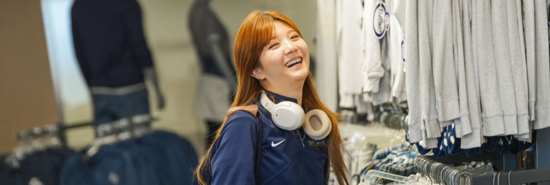 female student laughing in bookstore